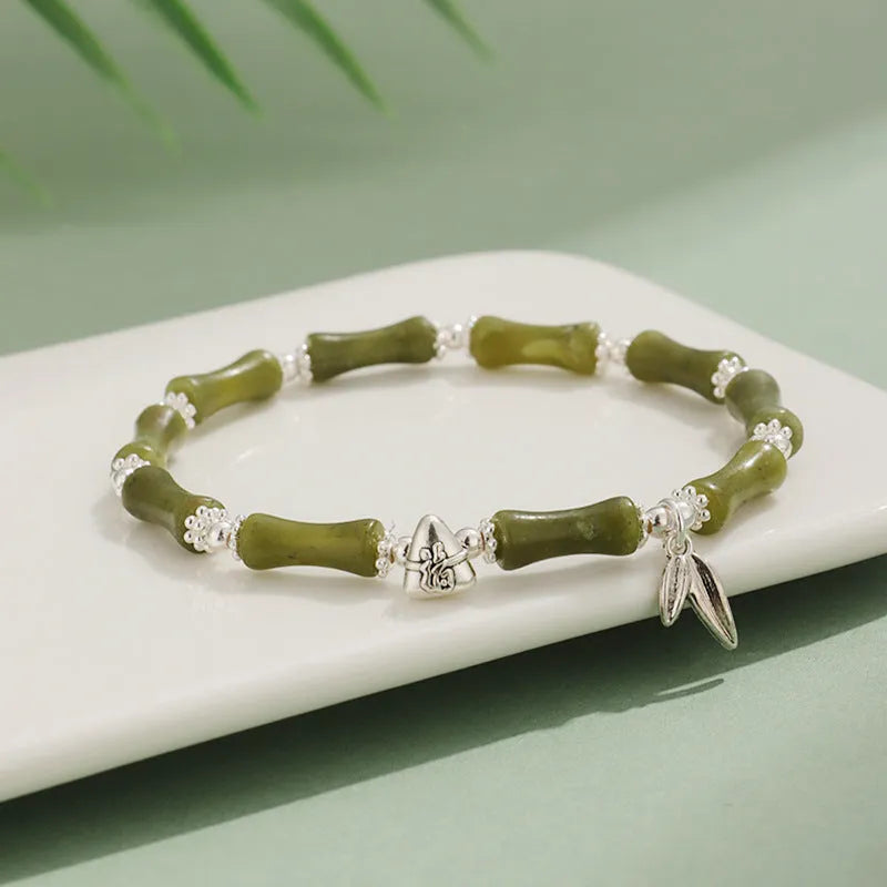 Green aventurine bamboo strawberry quartz crystal bracelet with mixed natural stones on wrist