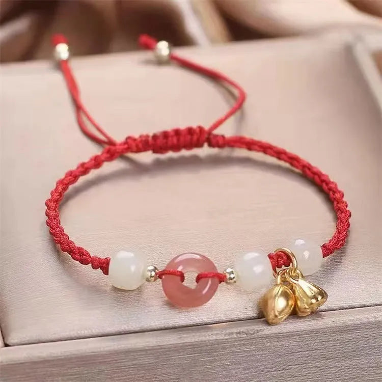 Hetian jade peace buckle bracelet on a brown strap, showing constellation detail.