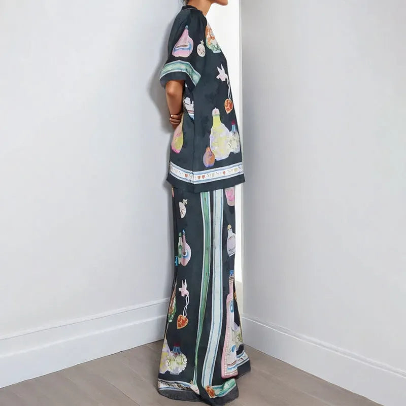 Black women's cardigan and trouser set with cartoon print, showing front view.