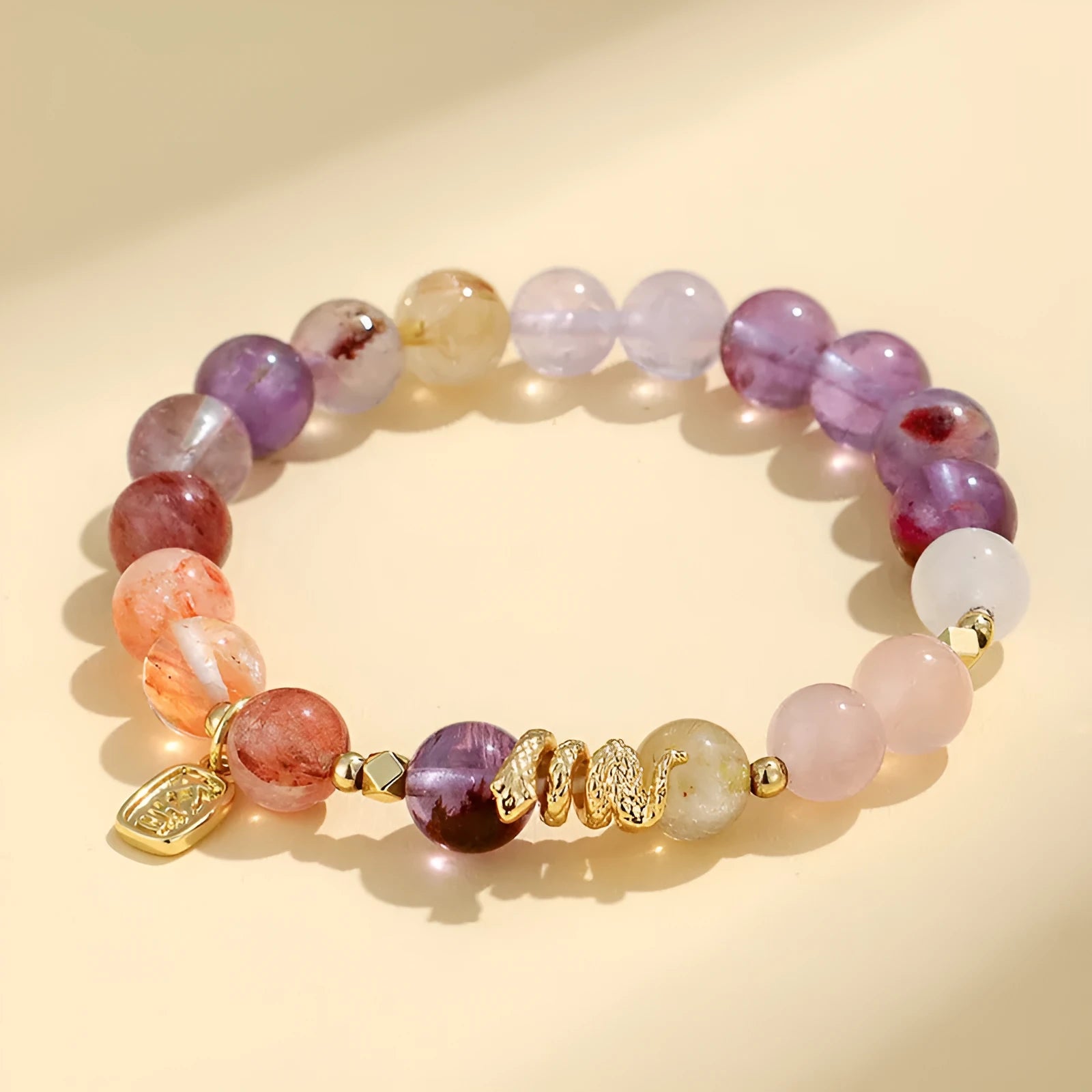 Women's crystal bracelet with lucky snake design and flower beads in amethyst colour