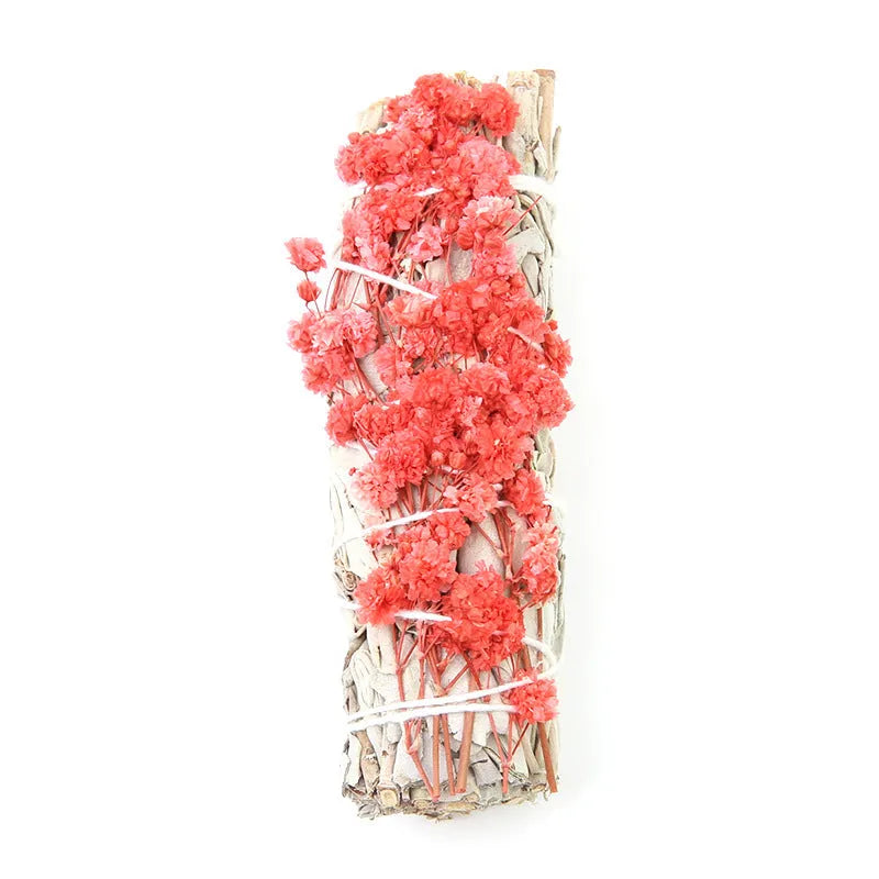 White sage and red rose petal colourful aromatherapy incense bundle on a wooden table