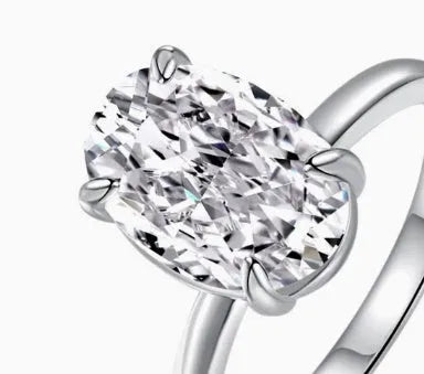 Oval gemstone ring in a four-claw setting on a silver band.