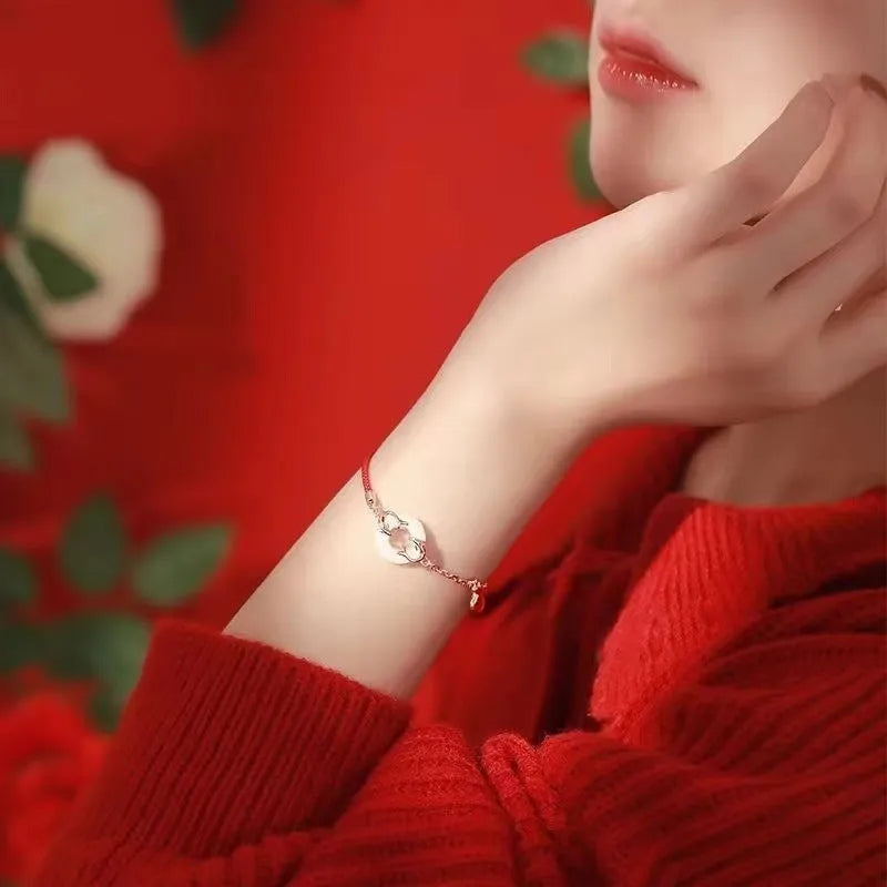Festive koi bracelet with peace buckle charm on red rope, featuring fish tail decorative elements in Japanese style