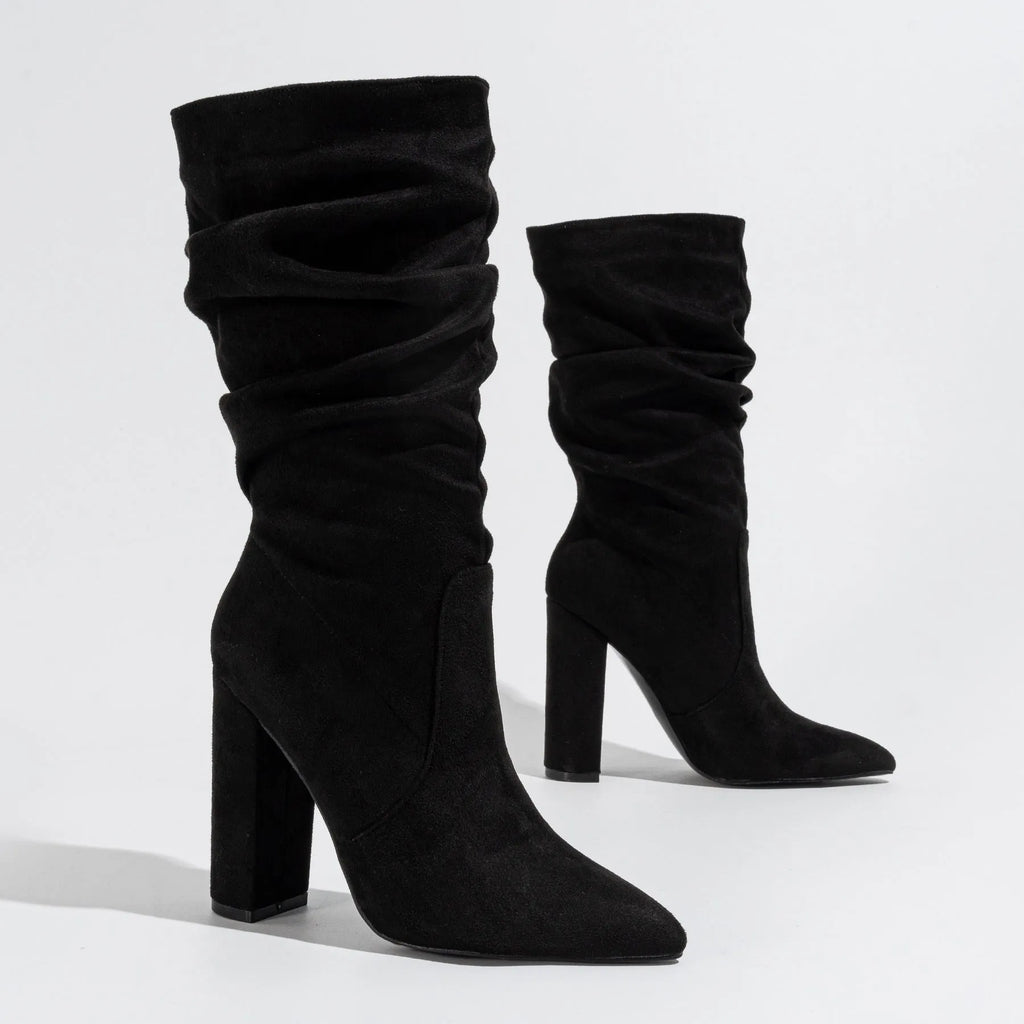 Women's black suede chunky high heel boots with pointed toe and mid-calf length.