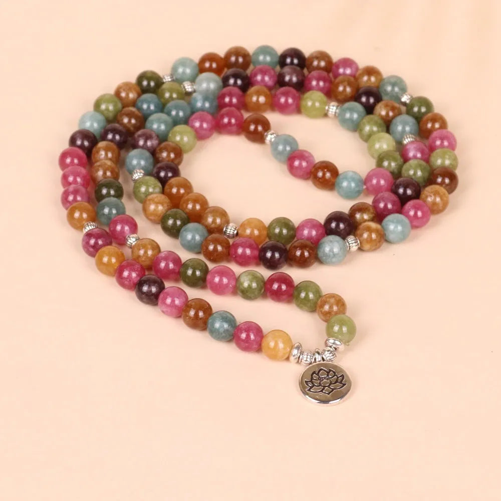 108-bead multi-layer bracelet with hanging lotus ornament in tourmaline-coloured alloy.