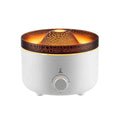 Small white volcano-shaped humidifier with simulated flame lighting and remote control on wooden table
