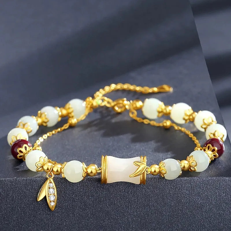 Bamboo style bracelet with electroplated coloured glass beads in a Ruyi flower design.