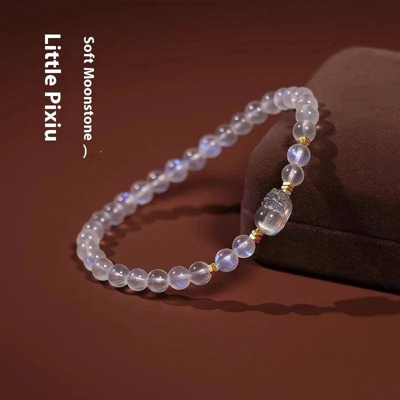 Close-up of a women's moonstone bracelet with zodiac animal design in a traditional Chinese style.