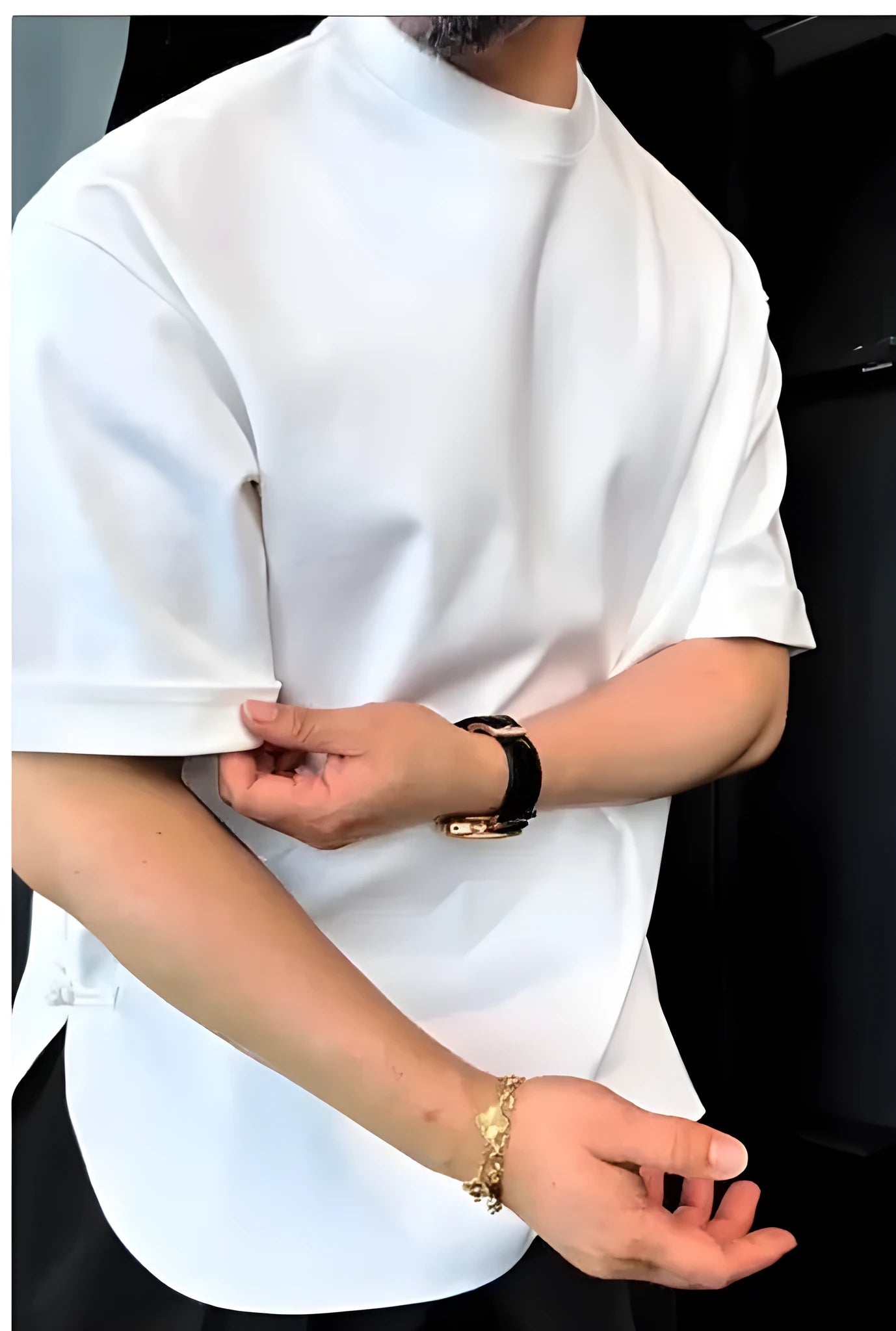Men's white T-shirt with button details and a round hemline on a hanger.