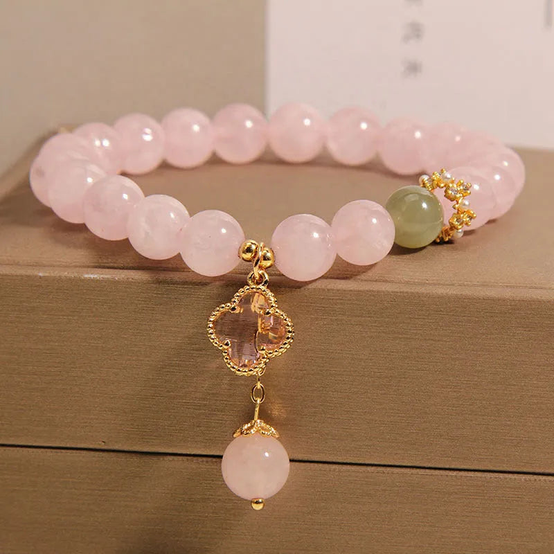 Pink crystal four-leaf clover pendant bracelet with alloy setting and rhinestone details