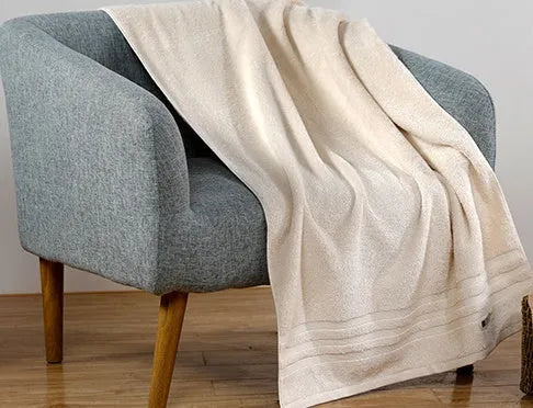 Beige and brown cotton towel set showing face cloth, hand towel and bath towel sizes.