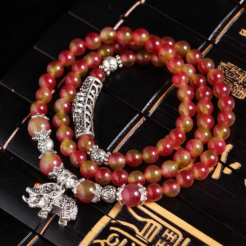 Handmade watermelon crystal bracelet with Chinese knot and geometric beads in 6mm or 8mm sizes.