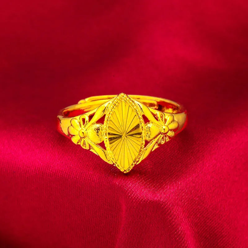 Gold-coloured geometric flower ring with textured surface and open design on brass