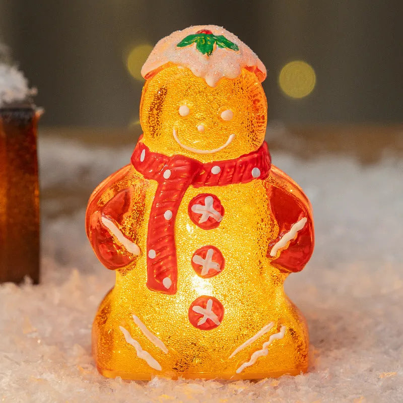 Glowing plastic Christmas ornaments with gingerbread man and snowman designs featuring red, white, and transparent scarves