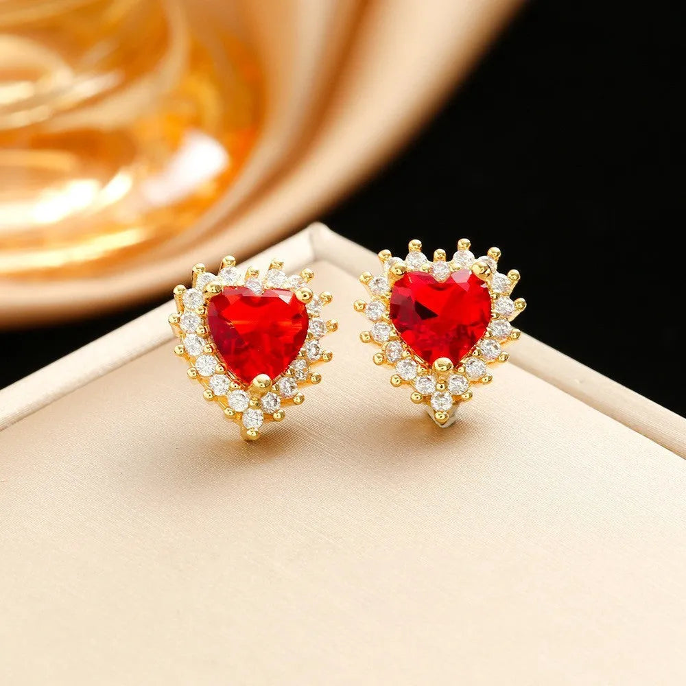 Gold red titanium steel jewellery set with hearts flower pendant, necklace, stud earrings, and ring.