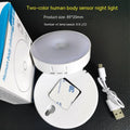 Compact round motion sensor LED night light in beige colour with USB charging cable