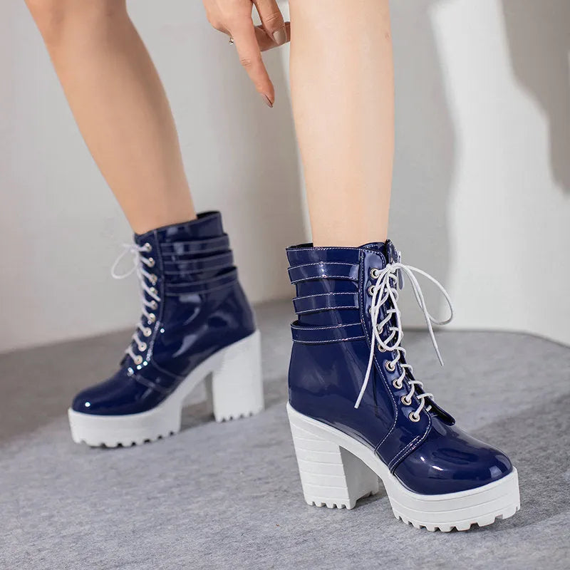 Women's black thick-heeled lace-up ankle boots with a round toe and waterproof platform sole.