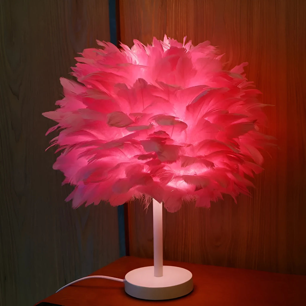 White handmade feather table lamp with metal base on a wooden desk, remote control visible, 30cm diameter