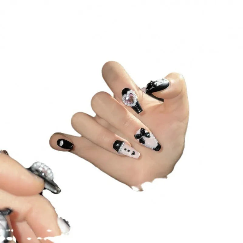 Handmade black peach heart nail art with detachable bow patterns on plastic armour suit