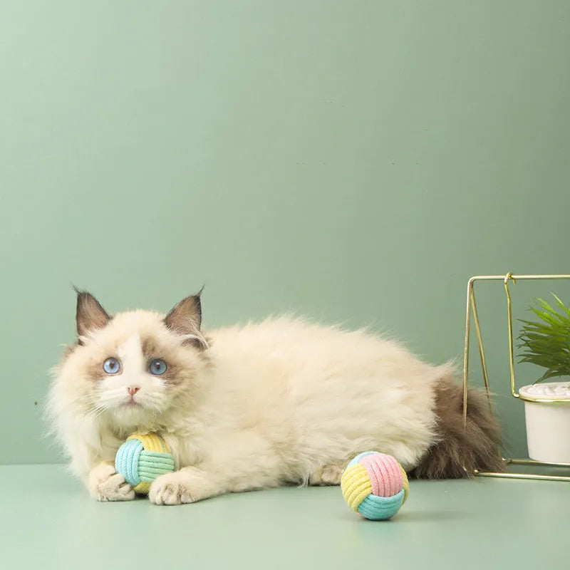 Handmade small blue powder, green blue, and pink green plush cotton ball cat toy for teeth grinding.