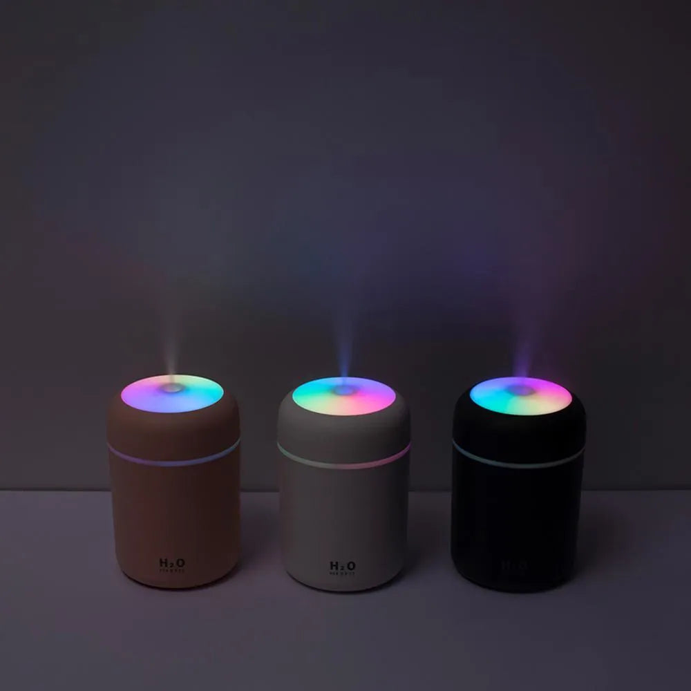 Car USB cup air humidifier with 300ml tank, two spray modes, colourful atmosphere light, in pink colour on desk