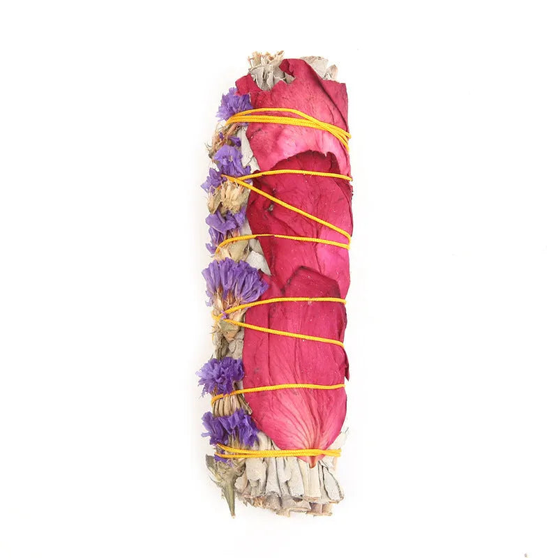 White sage and red rose petal colourful aromatherapy incense bundle on a wooden table
