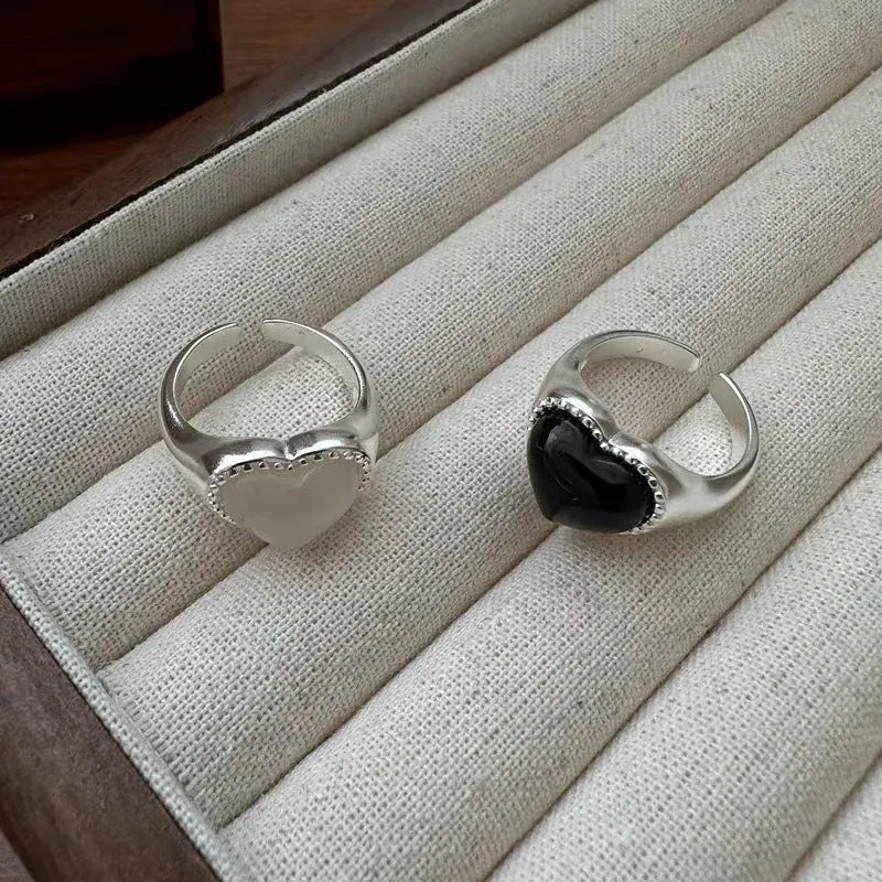 Sterling silver ring with a heart-shaped black agate stone and an adjustable open mouth design.