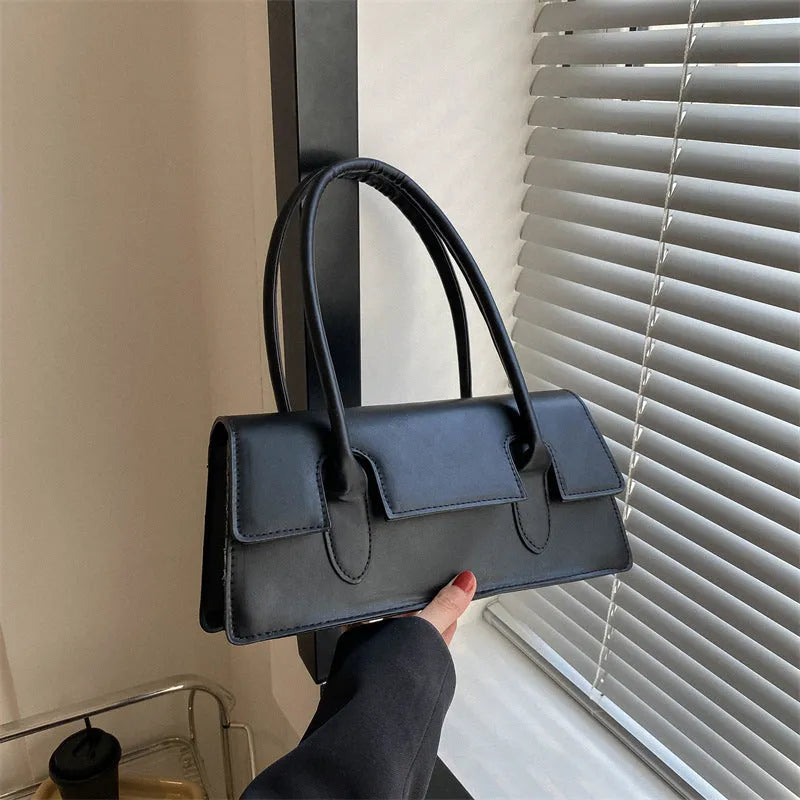 Women's horizontal square PU leather shoulder bag in black with stitching detail and sandwich pocket design