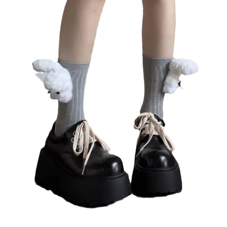 Black women's lace-up heels with a chunky rubber sole and a retro English muffin heel.