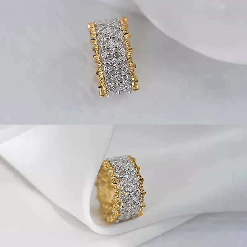 Geometric two-tone gold and silver zircon ring on a copper base, showing round stone detail.