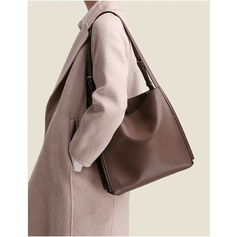 Brown genuine leather women's bucket bag with double shoulder straps and multiple internal organisers