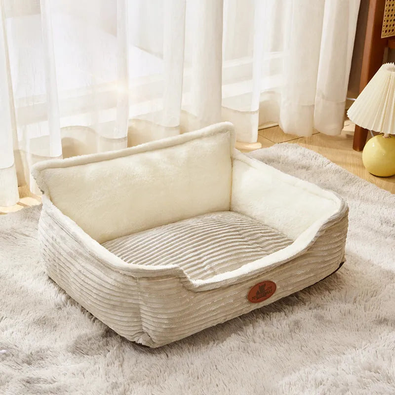 Coffee and white coloured removable washable dog kennel bed shown in small and medium sizes on a sofa and floor.