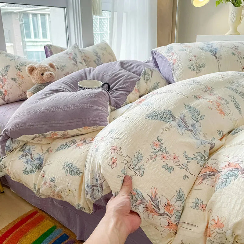 Aerobic jacquard cloud yarn four-piece bedding set with quilt cover, sheet, and pillowcases in a soft pattern.