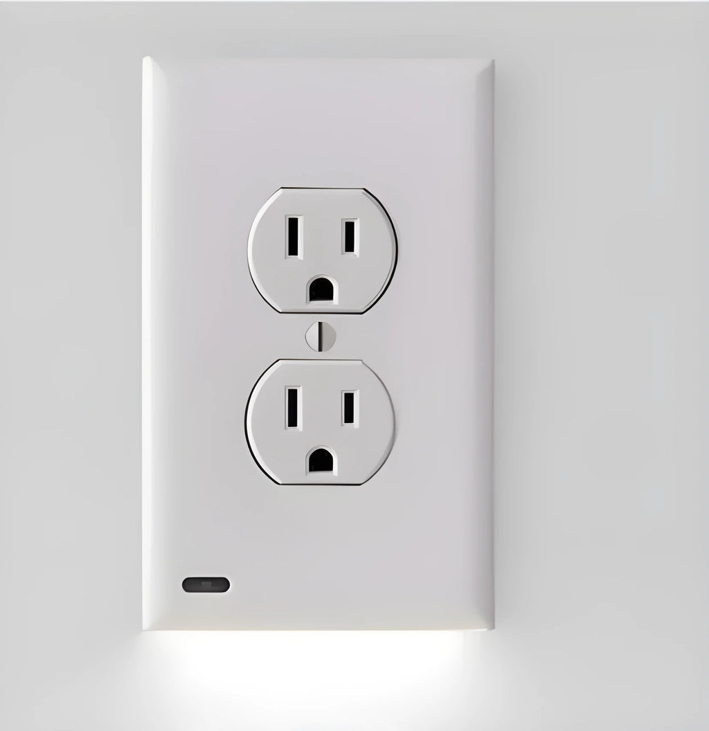 White plastic LED night light plugged into a standard UK wall socket.