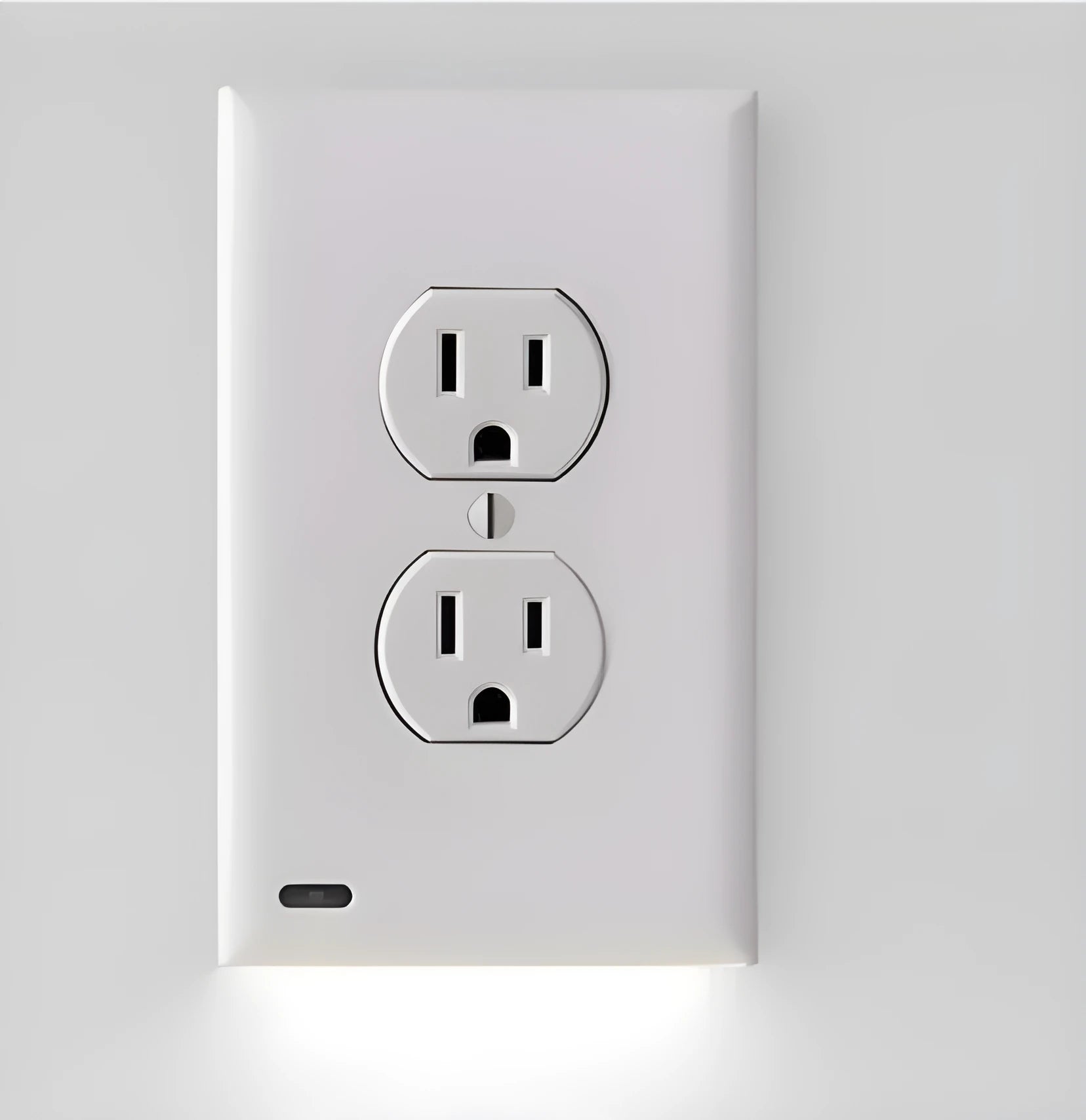 White plastic LED night light plugged into a standard UK wall socket.