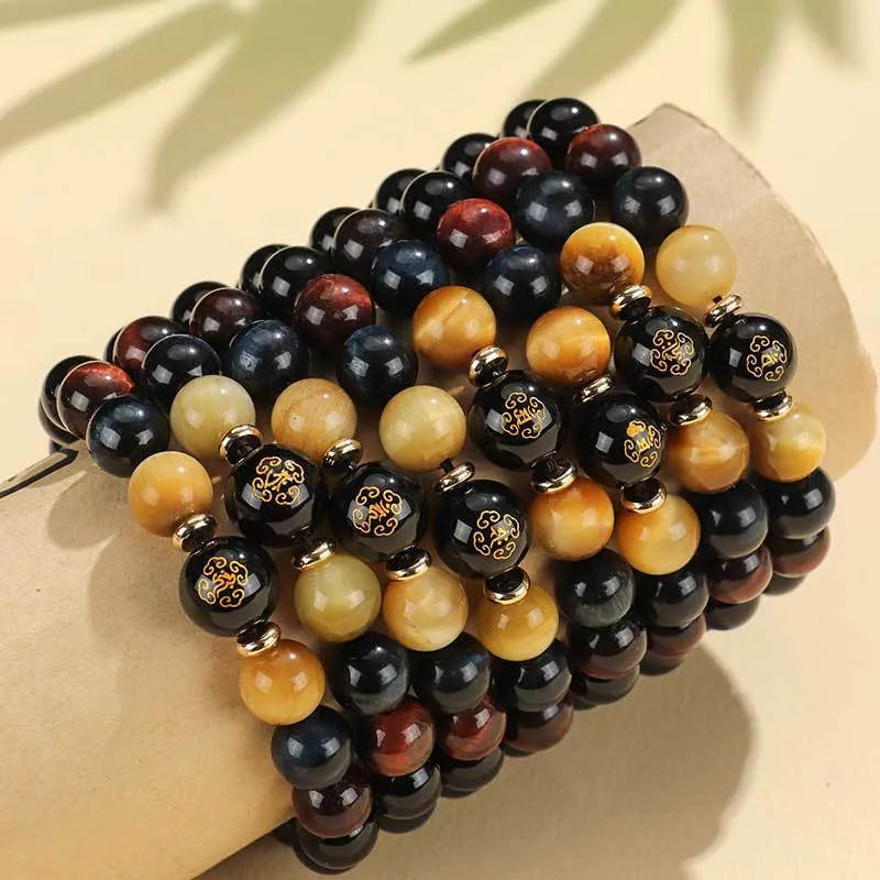 Manually crafted black agate beaded bracelet with gold, blue, and red tiger eye stones, showing ethnic zodiac design.