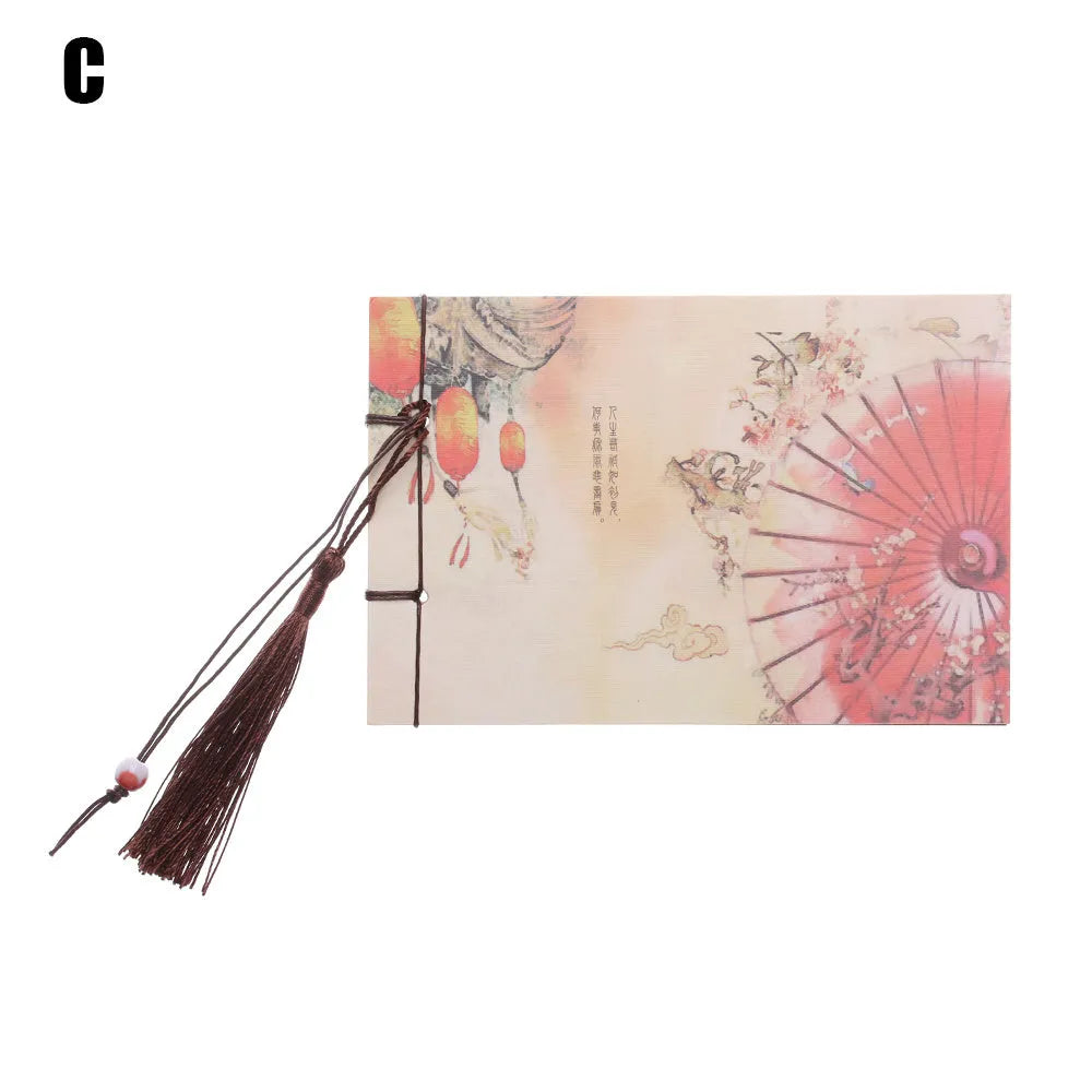 Kraft paper notebook with tassel bookmark showing hand-stitched binding and blank interior pages