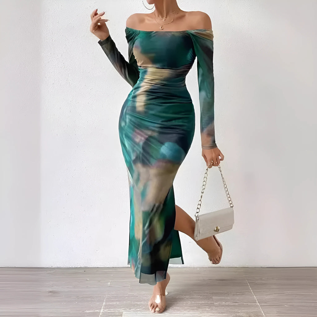 A long green mesh fishtail dress with a square collar, pleated detail, gradient colour, and a split hem.