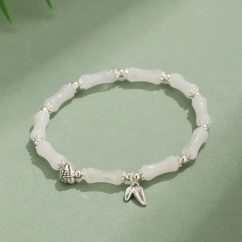Green aventurine bamboo strawberry quartz crystal bracelet with mixed natural stones on wrist