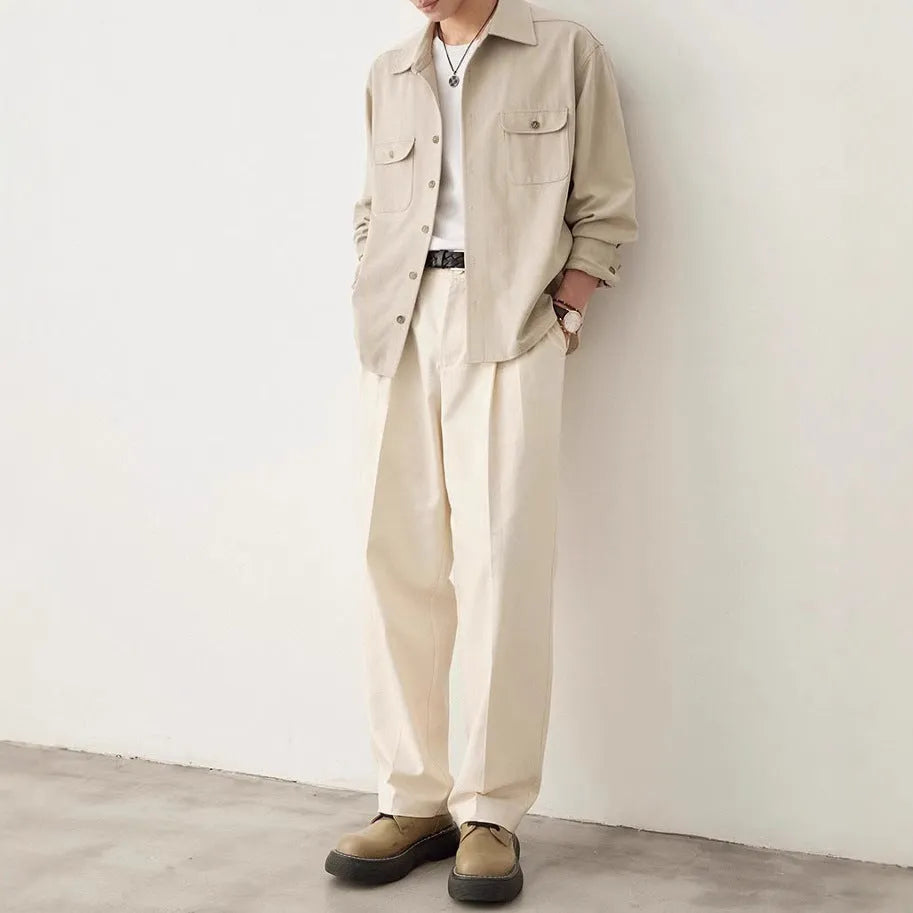 Men's light sand rice coloured long sleeve shirt with a simple lapel collar on a hanger.