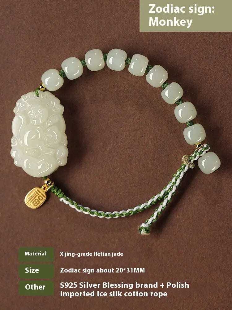 Hetian jade rabbit charm bracelet with sterling silver card on a white ice cotton rope.