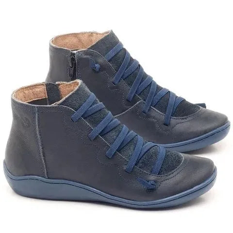 Women's casual flat ankle boots in various colours including black and leopard print, showing round toe and wedge heel.