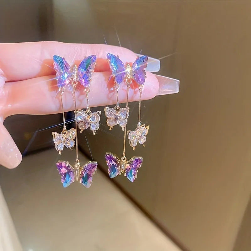 Blue and purple butterfly crystal tassel drop earrings for women on a white background.