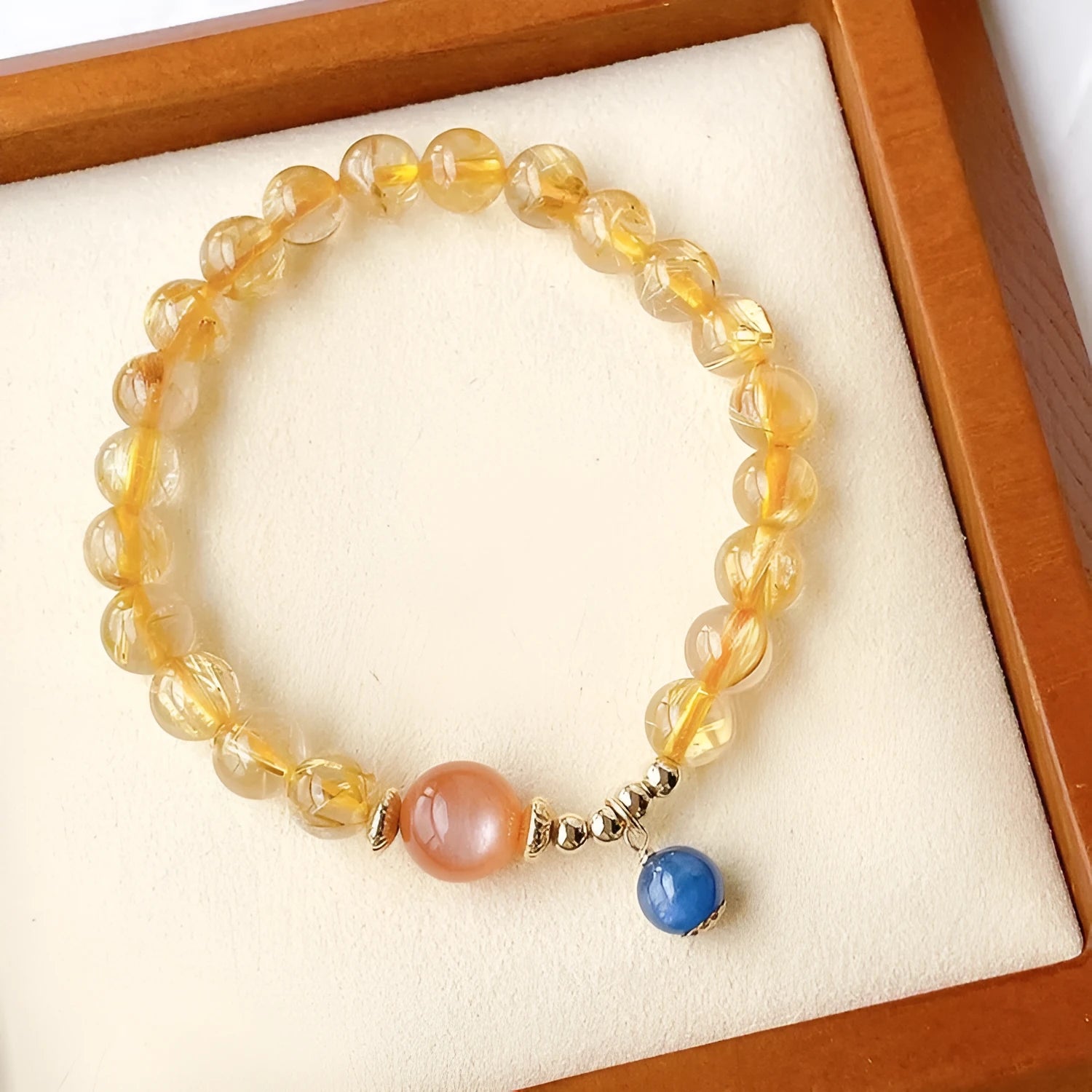 Women's gold rutilated quartz sunstone crystal bracelet with round beads in diamond pattern