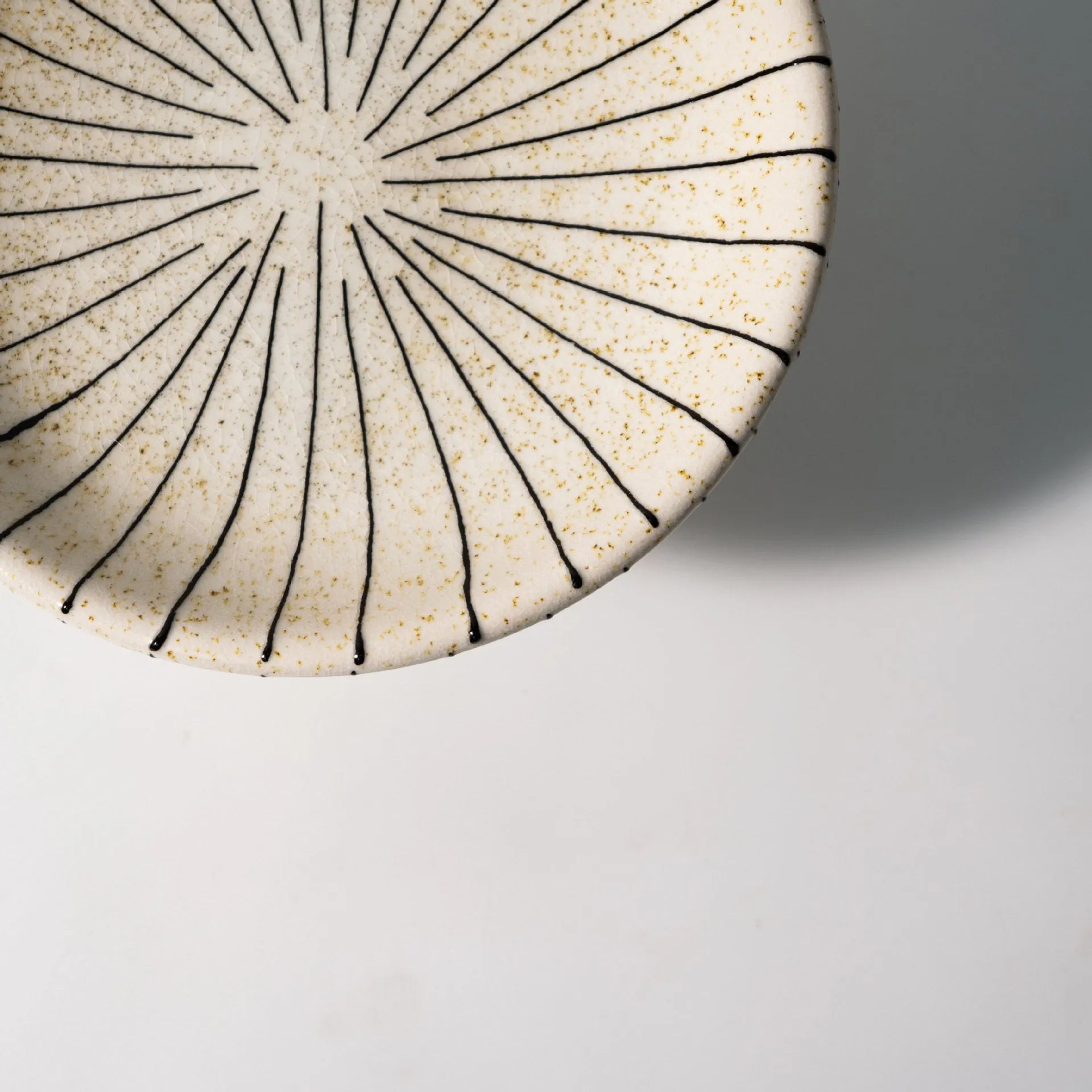 Black and white striped synthetic resin fruit dessert plate on a table