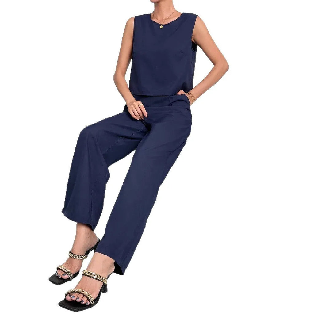 Women's red polyester two-piece set with sleeveless round-neck top and wide-leg trousers laid flat.