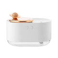 Green rotating planet shaped car humidifier with night light on a desk next to a USB cable.