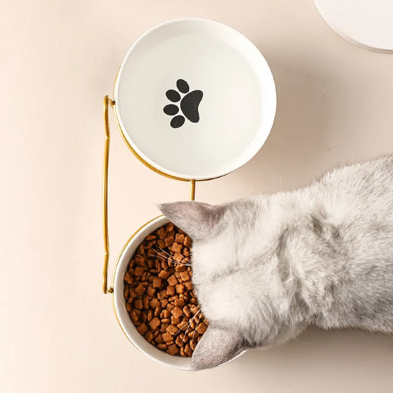 White ceramic cat bowl with cat paw pattern and black iron frame with cat ears