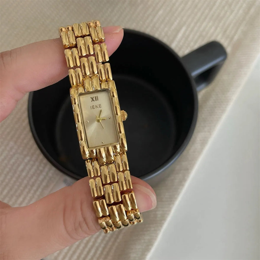 Women's bracelet watch with butterfly clasp showing 15mm dial and stainless steel case
