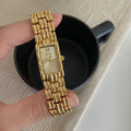 Women's bracelet watch with butterfly clasp showing 15mm dial and stainless steel case